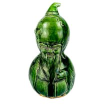 A Chinese green double gourd crackle glazed porcelain Buddha with a relief face. H. 21cm.