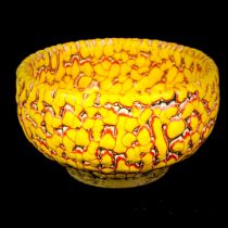 A Chinese yellow and red heavy-relief glazed pottery bowl. H. 6cm., Dia. 9cm.