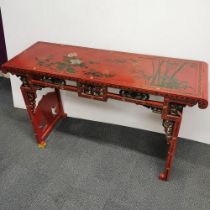 A Chinese red lacquer carved altar table with floral and bamboo decoration, 145 x 53 x 47cm.