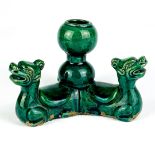 A Chinese triple-headed dark green crackle glazed pottery oil lamp. H. 9cm.