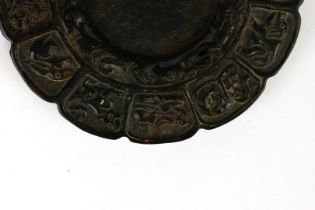 A Chinese carved brown jade/ hardstone ink grinding stone decorated with the twelve-year signs, Dia.