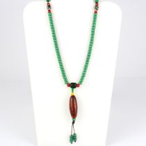 A string of Tibetan green glass prayed beads, folded L. 51cm.