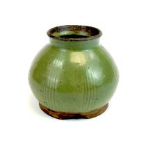 A large green glazed clay pot, possibly Korean, H. 21cm.