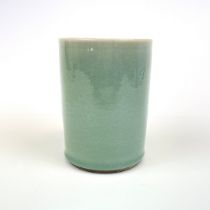 A Chinese celadon glazed porcelain brush pot, H. 15cm. Dia. 10.9cm.