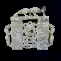 A Chinese carved jade model of a gateway surmounted with dragons, H. 15cm, W. 17cm.