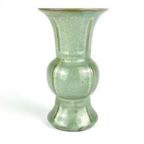 A Chinese celadon crackle glazed ribbed vase. H. 20cm. Condition: minor chip to rim.