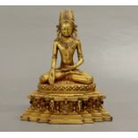 A Tibetan bronze stone set figure of the seated Buddha, H. 27cm.