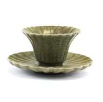 A Chinese lotus shaped crackle celadon glazed terracotta tea bowl and stand, dia. 13cm, H. 8cm.