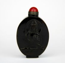 A Chinese carved horn snuff bottle decorated with Buddha and a vulture, H. 7.5cm.