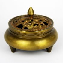 A Chinese gilt bronze censer with pierced lid depicting Mandarin ducks on a pond among lotus, Dia.