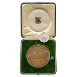 A LARGE COMMEMORATIVE BRONZE MEDAL COMMEMORATING THE MAIDEN VOYAGE OF THE R.M.S. QUEEN MARY, 1936