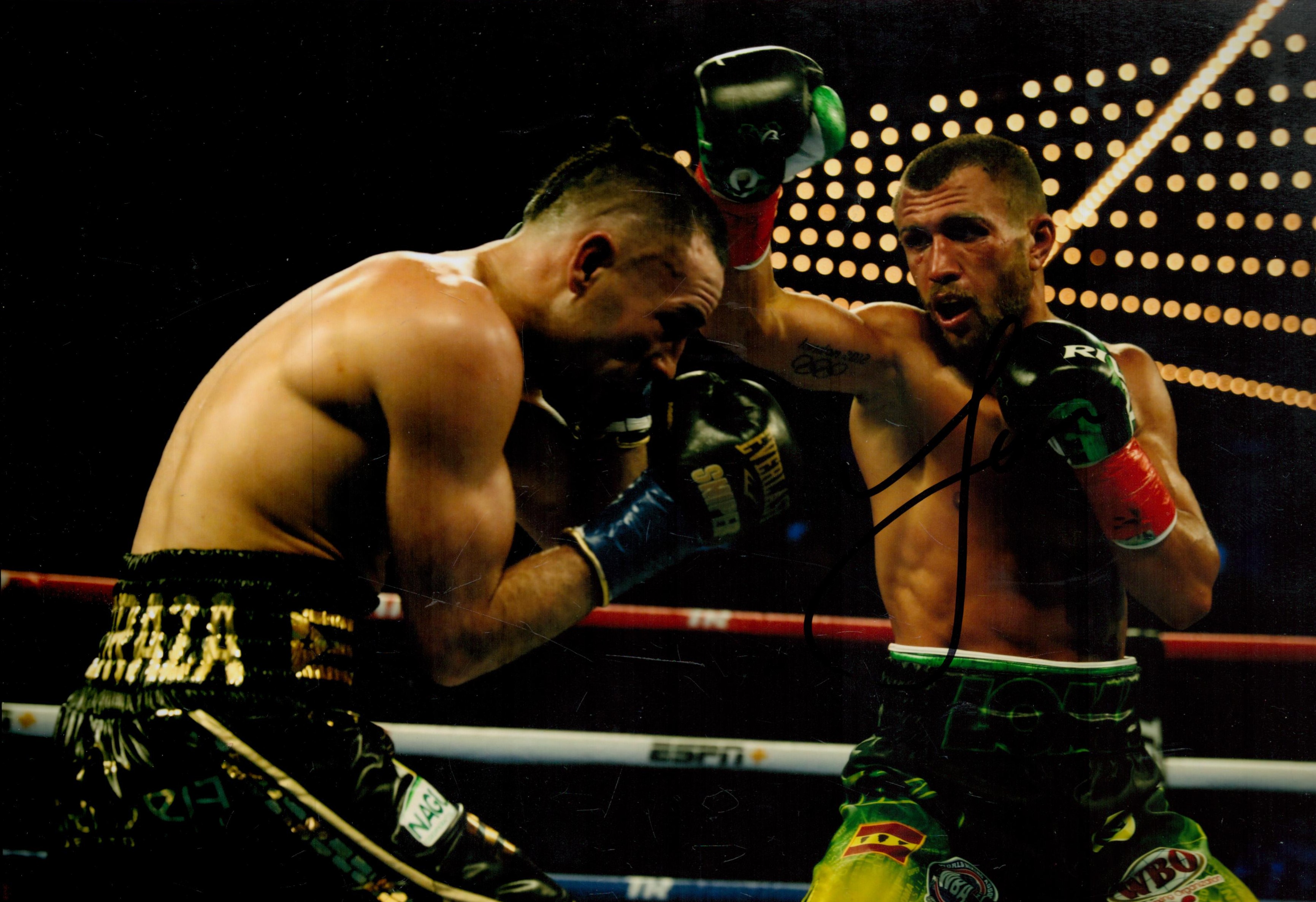 Boxing Star Vasiliy Lomachenko Signed 12x8 inch Colour In Action Photo. Signed in black ink. Good