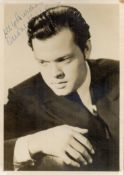 Orson Welles Signed 7x5 inch Vintage Black and White Photo. Signed in blue ink. Fair condition.. All