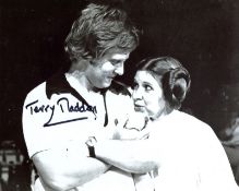 Star Wars movie director Terry Madden signed 8x10 Carrie Fisher candid photo. All autographs come