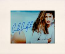 Cindy Crawford Signed 9 x 6 inch approx Colour Photo, Mounted. Signed in blue ink. Good Condition.