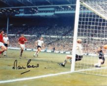 Football. Martin Peters Signed 10x8 colour photo. Photo shows the Peters watching to see if