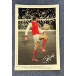 Football. Charlie George Signed 18x12 colourised photo. Photo shows George doing keepy uppies in
