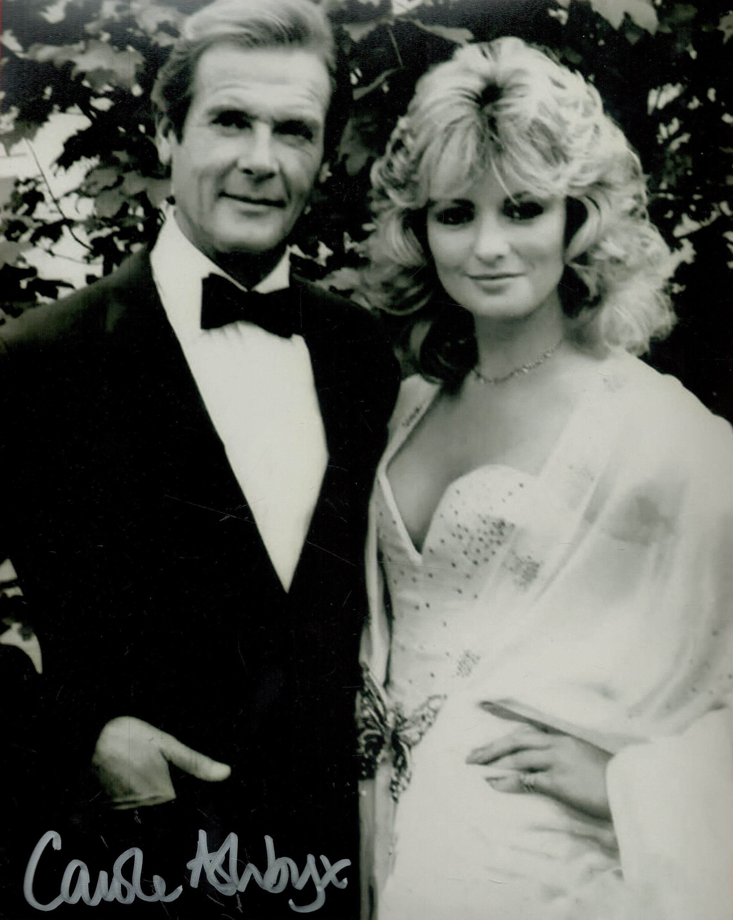 Carole Ashby signed 10 x 8 inch b/w photo with Roger Moore James Bond. Good Condition. All