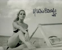 Martine Beswick signed 10 x 8 inch b/w in swim suit sitting on Motor Boat. James Bond 007 Actress.
