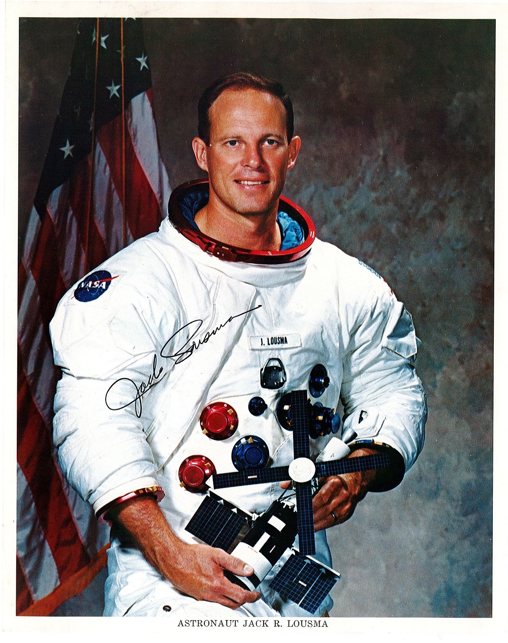 Astronaut Jack R Lousma Signed 10x8 inch Colour NASA Spacesuit Photo. Signed in black ink. Good