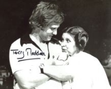 Star Wars director Terry Madden signed 8x10 candid photo with Carrie Fisher. Good Condition. All