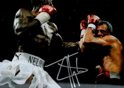 Boxing Star Johnny Nelson Signed 10x8 inch Colour In Action Photo. Good condition. All autographs