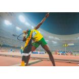 Athletics Usain Bolt signed 12x8 colour photo pictured doing his iconic celebration. Usain St. Leo