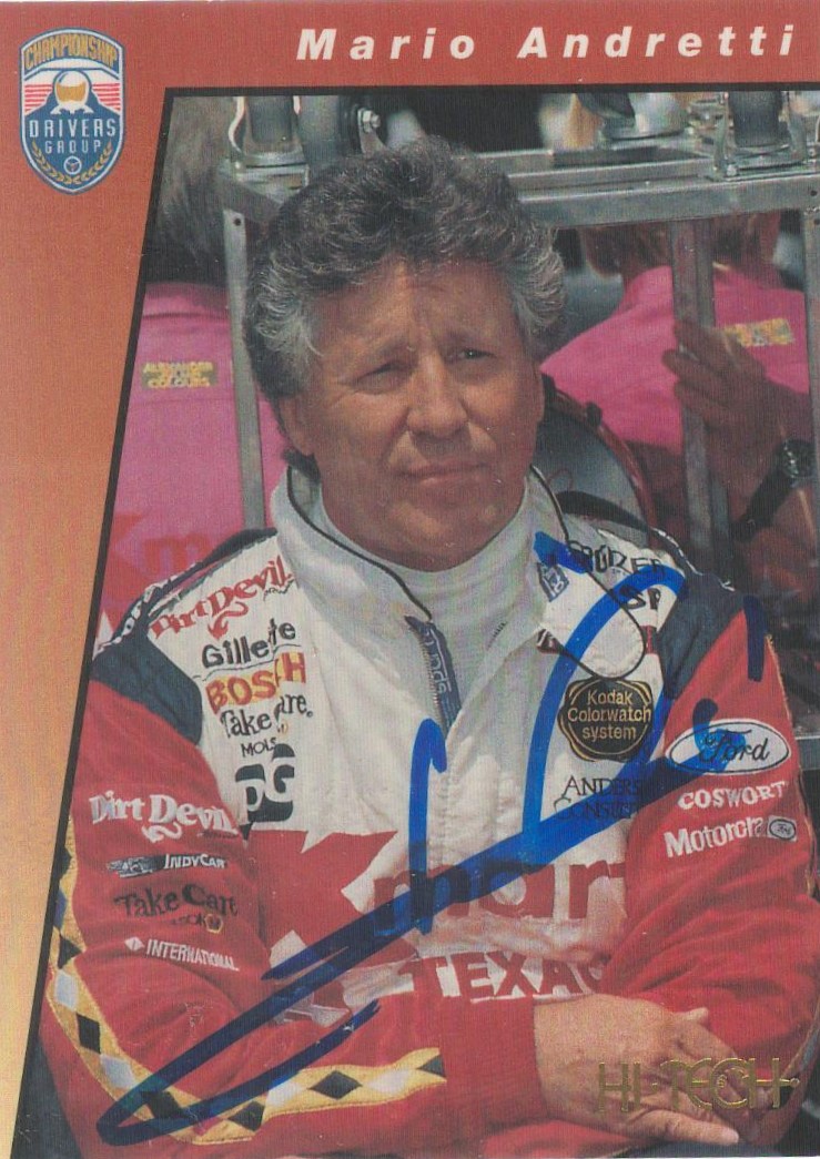 A trading card nicely signed in blue sharpie pen by American former racing driver Mario Andretti.