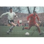 Ian St John signed 12x8 inch colour photo pictured in action for Liverpool. Good condition. All