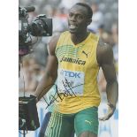 Usain Bolt signed 16x12 inch colour photo. Good condition. All autographs are genuine hand signed
