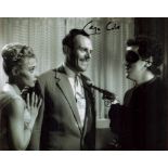 George Cole signed 10 x 8 inch b w photo in mask holding a gun to Terry Thomas. Good condition.