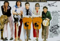 The Boomtown Rats 4 Members Signed 12 x 8 inch Colour Promo Photo. Affixed to A4 Black Card.