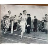 Sir Roger Bannister 4 min mile athlete signed 10 x 8 inch b/w running action photo. Sir Roger