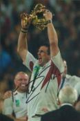 Rugby Union Martin Johnson signed 12x8 inch colour photo pictured lifting the World Cup trophy after