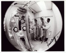 Frank Borman signed 10x8 inch vintage black and white photo picturing the crew's space suits. From