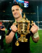 Rugby Union Dan Carter signed 10x8 inch colour photo pictured hold the Webb Ellis World Cup. Good