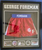 Boxing George Foreman signed 33x38 boxing shorts display.. Good condition. All autographs are