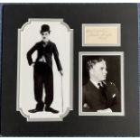 Charlie Chaplin 13x13 inch overall mounted signature piece includes signed album page dated 1933 and