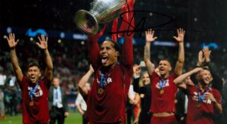 Virgil van Dijk signed 12x8 inch colour photo pictured celebrating with the Champions League trophy.