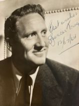 Spencer Tracy signed 6 x 4 b/w photo dated 1964. Two tape marks to reverse, priced accordingly. Good