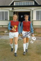 Autographed GEOFF HURST 12 x 8 photo : Col, depicting West Ham United's Bobby Moore and GEOFF