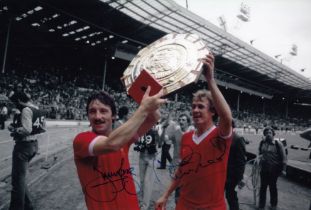 Autographed LIVERPOOL 12 x 8 photo : Colorized, depicting JIMMY CASE and PHIL NEAL holding aloft the