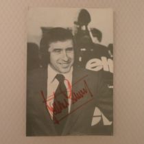 Jackie Stewart Formula One Legend autograph on a 9.25 inch x 6.25 inch black and white photograph of
