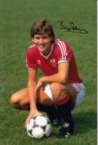 Autographed BRYAN ROBSON 12 x 8 photo : Col, depicting Man United captain BRYAN ROBSON striking a