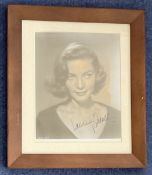 Lauren Bacall signed 14x12 inch framed and mounted black and white photo.. Good condition. All