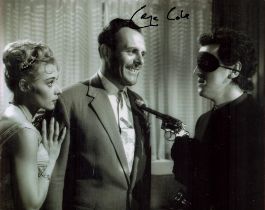 George Cole signed 10 x 8 inch b w photo in mask holding a gun to Terry Thomas. Good condition.