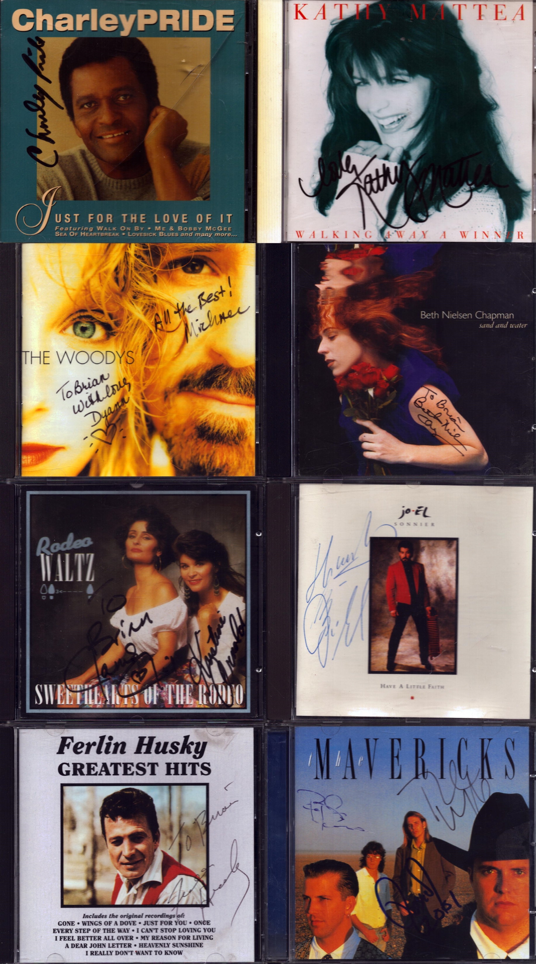 Music collection of 8 signed CDs including names of The Woods, Ferlin Husky, Jo-El Sonnier and more.