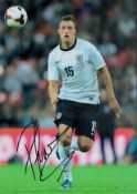 Phil Jones Signed England 8x12 Photo. Good condition. All autographs come with a Certificate of