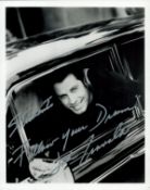 John Travolta signed 10x8 inch black and white photo inscribed Follow your Dreams. Good Condition.