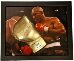 Evander Holyfield signed Gold Boxing Glove displayed on a colour photo of Good Condition. All signed